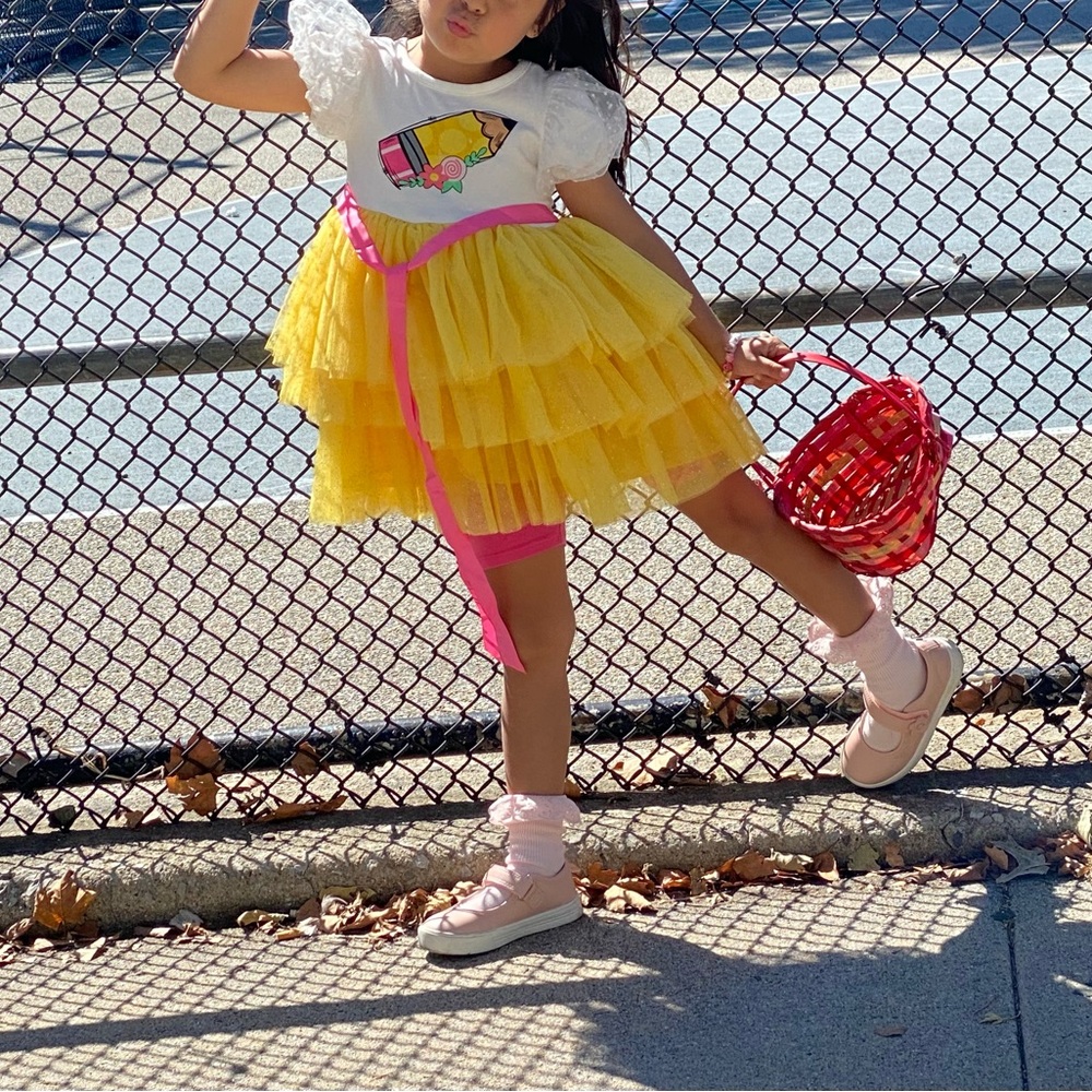 Vibrant Kids Dress with Yellow Skirt and Pink Ribbon
